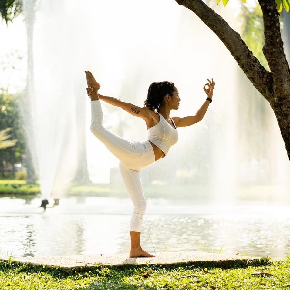 Nicha, certified yoga teacher in Chiang Mai, practising outdoors at golden hour